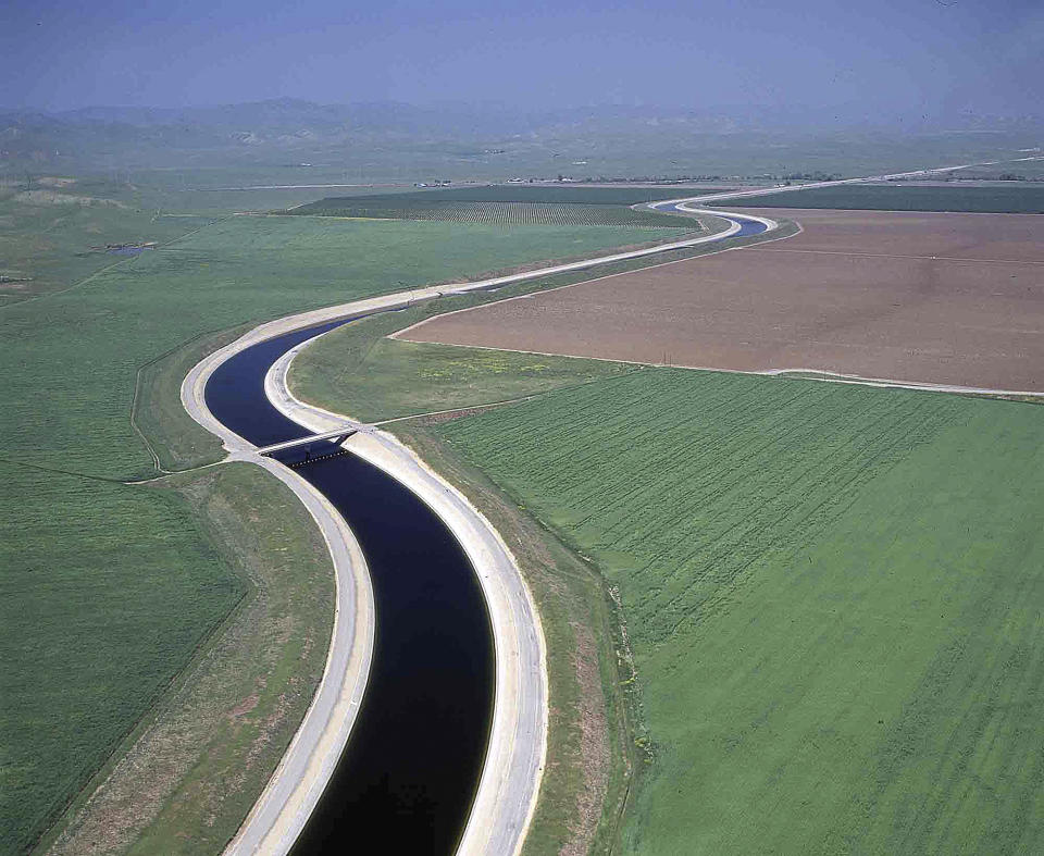 File - This undated file photo released by the California Department of Water Resources shows water making its way south through the Central Valley by way of the California Aqueduct. The California Aqueduct has been ferrying water from the state’s verdant north to the south’s arid croplands and cities since Gov. Jerry Brown’s father was in office half a century ago. But now, amid one of the worst droughts on record, a group of farmers want to route some of that water back uphill. (AP Photo/California Department of Water Resources, Dale Kolke, File)