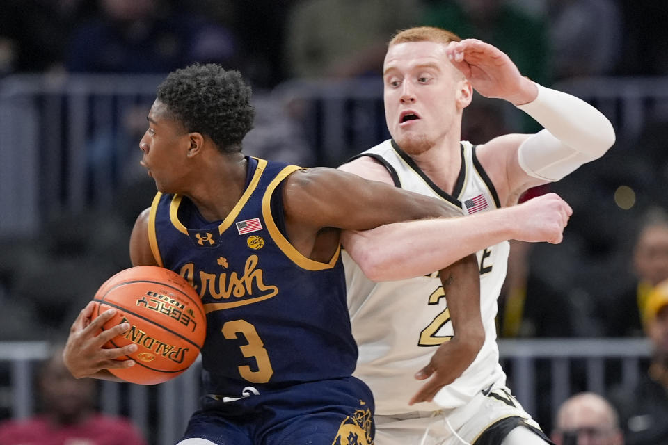 Notre Dame guard Markus Burton (3) gets tangled up with Wake Forest guard Cameron Hildreth (2) during the first half of an NCAA college basketball game in the second round of the Atlantic Coast Conference tournament, Wednesday, March 13, 2024, in Washington. (AP Photo/Susan Walsh)