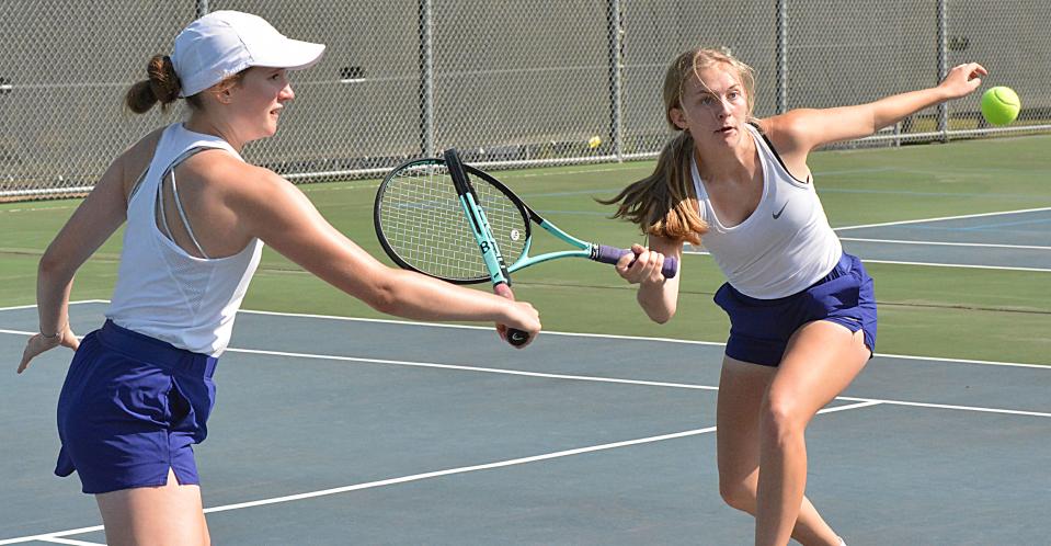 Watertown's Faith Berg (right) and Sophia Nichols each reach for the ball during their second-flight doubles match against Harrisburg in a high school girls tennis triangular on Tuesday, Sept. 12, 2023 at Highland Park.