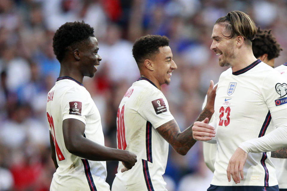 England's Bukayo Saka, left, reacts after scoring his side's fourth goal during the World Cup 2022 group I qualifying soccer match between England and Andorra at Wembley stadium in London, Sunday, Sept. 5, 2021. (AP Photo/Ian Walton)