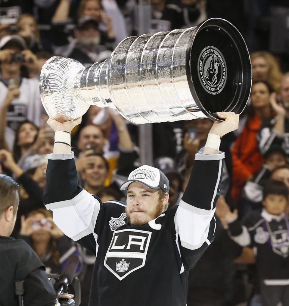 Los Angeles Kings' Dustin Brown celebrates with the Stanley Cup after the Kings' defeated the New York Rangers in Game 5 of their NHL Stanley Cup Finals hockey series in Los Angeles, California, June 13, 2014. REUTERS/Lucy Nicholson (UNITED STATES - Tags: SPORT ICE HOCKEY TPX IMAGES OF THE DAY)