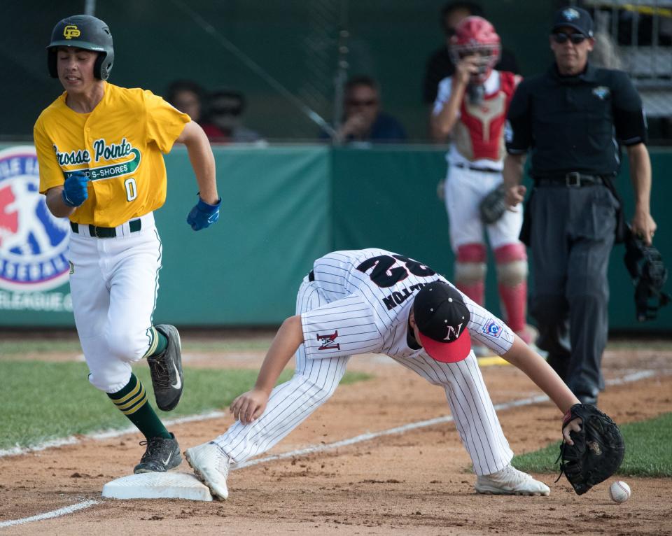 Ryan Knaebel of Michigan hustles out a play at first that was dropped by Blaine Hamilton of the Indiana squad, during Michigan's 13-0 victory in the regional finals, Grand Park, Westfield, Saturday, Aug. 11, 2018. The Grosse Pointe squad will represent the Great Lakes region in the upcoming Little League World Series. 