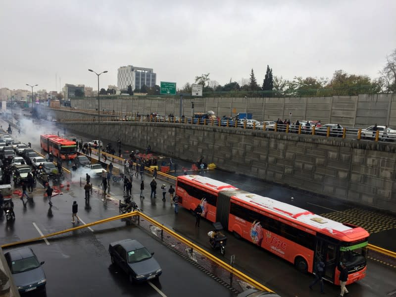 People protest against increased gas price, on a highway in Tehran