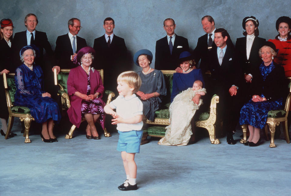 Prince Harry was christened at Windsor Castle on Dec. 21, 1984. In this official photo, he and his mother are surrounded by royal relatives and godparents amused at the antics of young Prince William. (Photo: Getty Images)