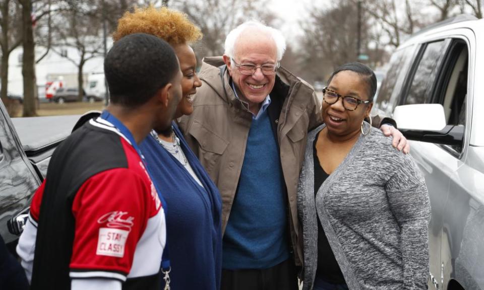 Sanders visits custodian Davonta Bynes, from left, principal DaRhonda Evans-Stewart and social worker Kim Little outside a polling location in Detroit.