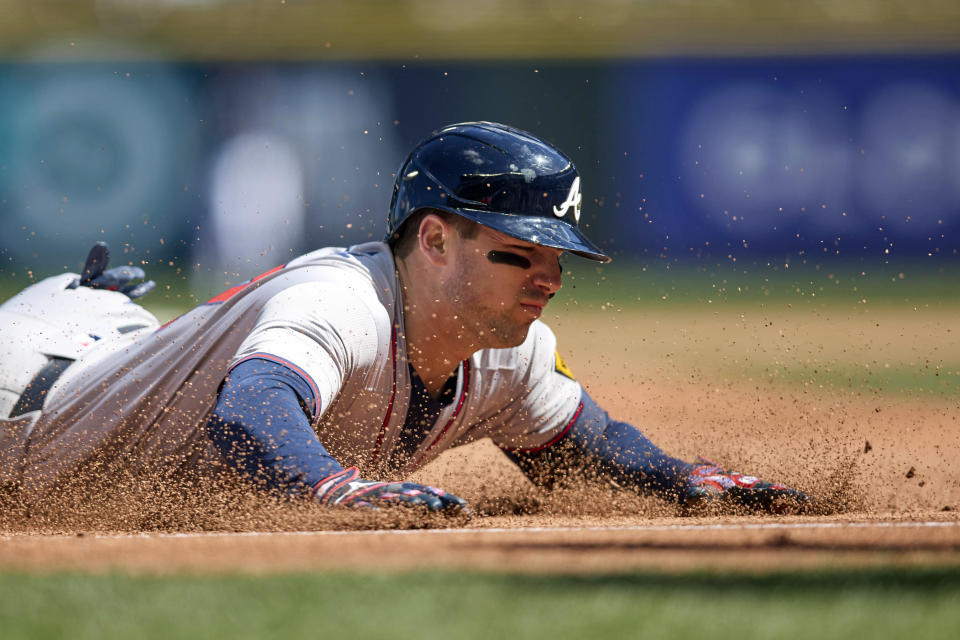 Atlanta Braves' Austin Riley slides into third on a two RBI triple against the Seattle Mariners during the fourth inning of a baseball game, Wednesday, May 1, 2024, in Seattle. (AP Photo/John Froschauer)