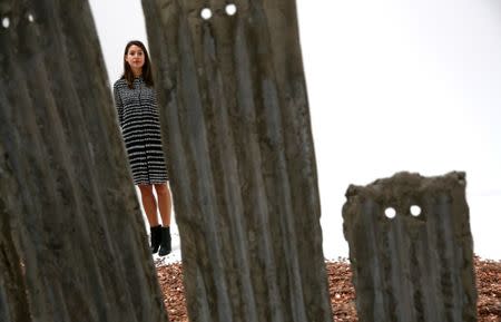 A gallery assistant poses with work by Michael Dean from his nominated exhibition "Sic Glyphs" at a preview of the Turner Prize in London, Britain September 26, 2016. REUTERS/Neil Hall