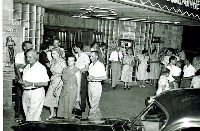 A black and white portrait shows people leaving the Mars Theater in the 50s.