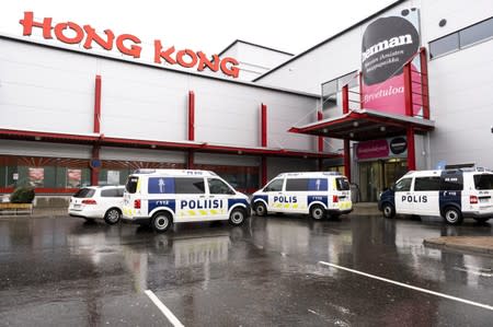 Police vans are seen in front of the Herman shopping center where the Savo Vocational College is located in Kuopio