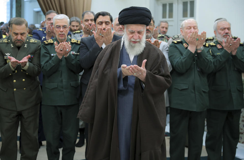 In this photo released by the official website of the office of the Iranian supreme leader, Supreme Leader Ayatollah Ali Khamenei, center, leads a prayer during his meeting with a group of senior military leaders, in Tehran, Iran, Sunday, April 21, 2024. Iran's supreme leader on Sunday dismissed any discussion of whether Tehran's unprecedented drone-and-missile attack on Israel hit anything there, a tacit acknowledgment that despite launching a massive assault, few projectiles actually made through to their targets. (Office of the Iranian Supreme Leader via AP)