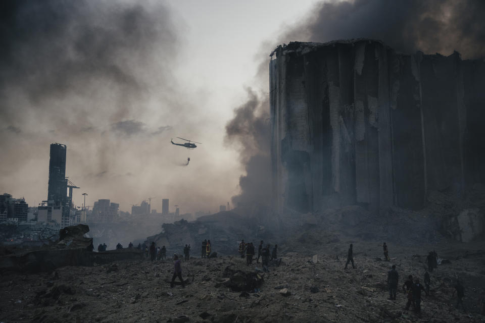 In this image released by World Press Photo, Thursday April 15, 2021, by Lorenzo Tugnoli, Contrasto, for The Washington Post, part of a series titled Port Explosion in Beirut, which won first prize in the Spot News Stories category, shows Firefighters work to put out the fires that engulfed warehouses in Beirut, Lebanon, on August 4, 2020, after a massive explosion in the port. Up to ten firefighters died in the blast. (Lorenzo Tugnoli, Contrasto, for The Washington Post, World Press Photo via AP)