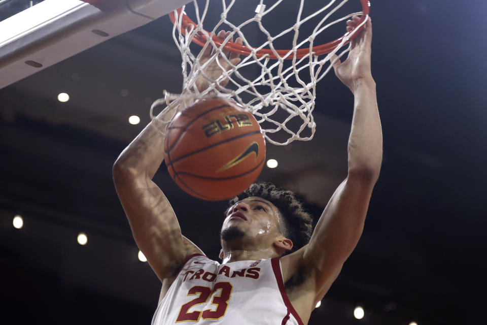 Southern California forward Max Agbonkpolo dunks against Eastern Kentucky during the first half of an NCAA college basketball game Tuesday, Dec. 7, 2021, in Los Angeles. (AP Photo/Ringo H.W. Chiu)