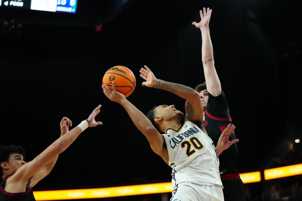 California guard Jaylon Tyson shoots the ball against Stanford forwards Jaylen Thompson and Maxime Raynaud, March 13, 2024, in Las Vegas.