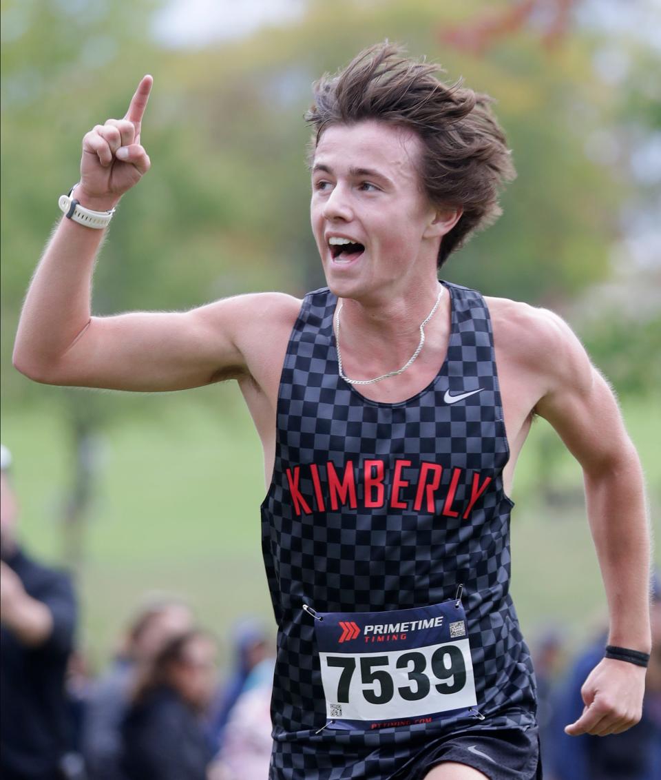 Kimberly's Logan Salzmann crosses the finish line during the Fox Valley Association Cross Country Championships on Oct. 12 at Countryside Golf Course in Kaukauna.