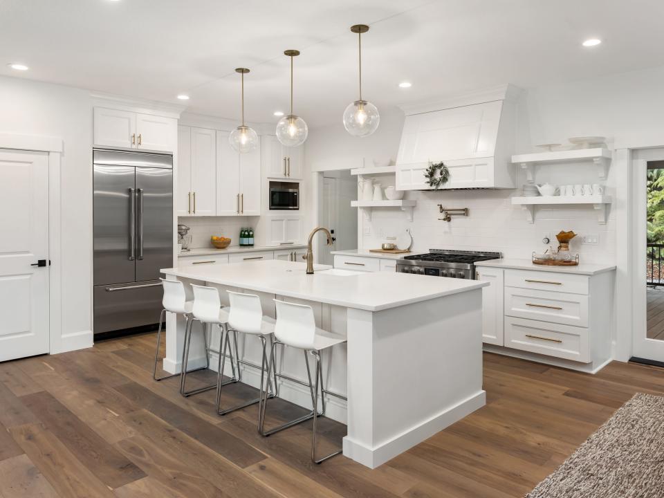 White kitchen in home with hardwood floors