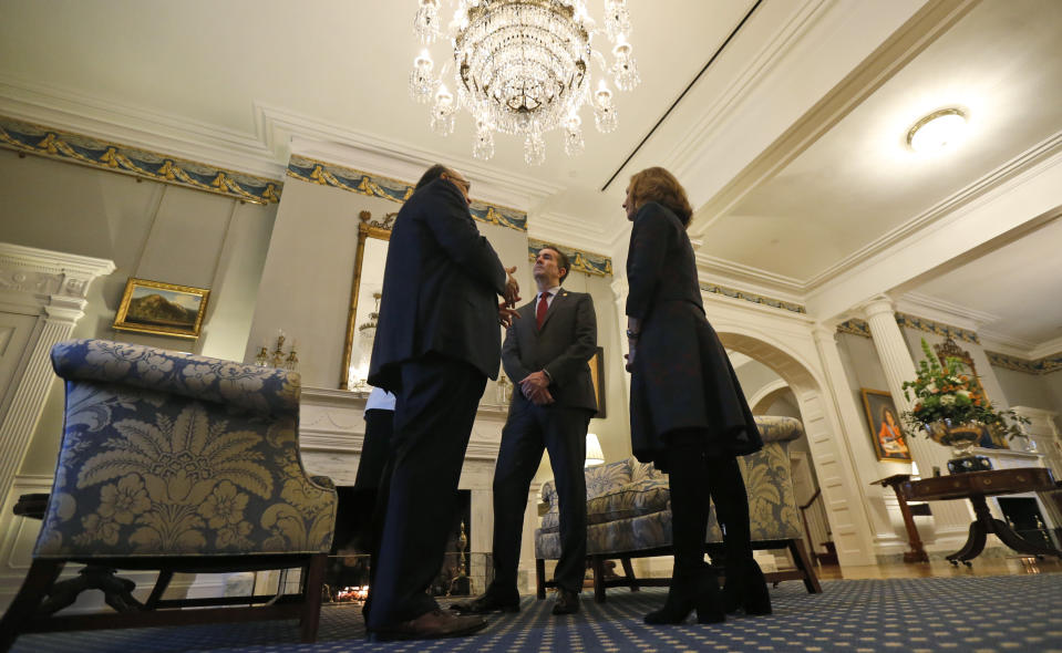 Virginia Gov. Ralph Northam, center, and his wife, Pam ,right, talk with former Virginia Union University president, Rev. Claude Perkins, left, at a breakfast at the Governors Mansion at the Capitol in Richmond, Va., Friday, Feb. 22, 2019. The breakfast was for The Richmond 34 were a group of African Americans who defied segregation laws in the 1960's (AP Photo/Steve Helber)