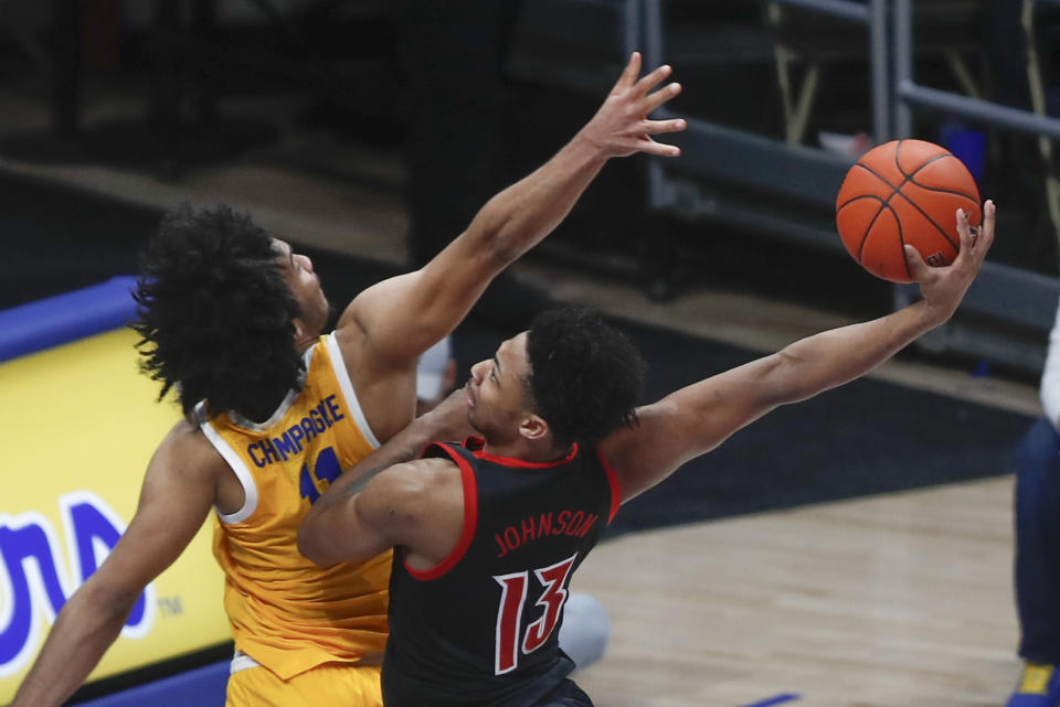 Louisville's David Johnson (13) goes to the basket at Pittsburgh's Justin Champagnie defends during the second half of an NCAA college basketball game Tuesday, Jan. 14, 2020, in Pittsburgh. Johnson missed the dunk. (AP Photo/Keith Srakocic)