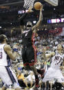 Miami Heat's LeBron James (6) goes up for a shot against New Jersey Nets' Shelden Williams, left, and Gerald Green (14) in the first quarter of an NBA basketball game, Monday, April 16, 2012, in Newark, N.J. (AP Photo/Julio Cortez)