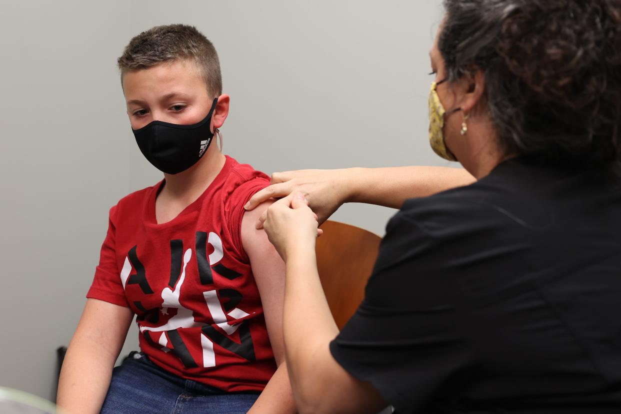 Grayson Rantilla, 11, from Rootstown gets his first dose of the COVID-19 vaccine at NEOMED’s COVID-19 clinic for 5-11 year olds.