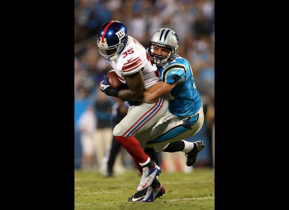 Andre Brown #35 of the New York Giants runs with the ball in the first half against Luke Kuechly #59 of the Carolina Panthers at Bank of America Stadium on September 20, 2012 in Charlotte, North Carolina.  