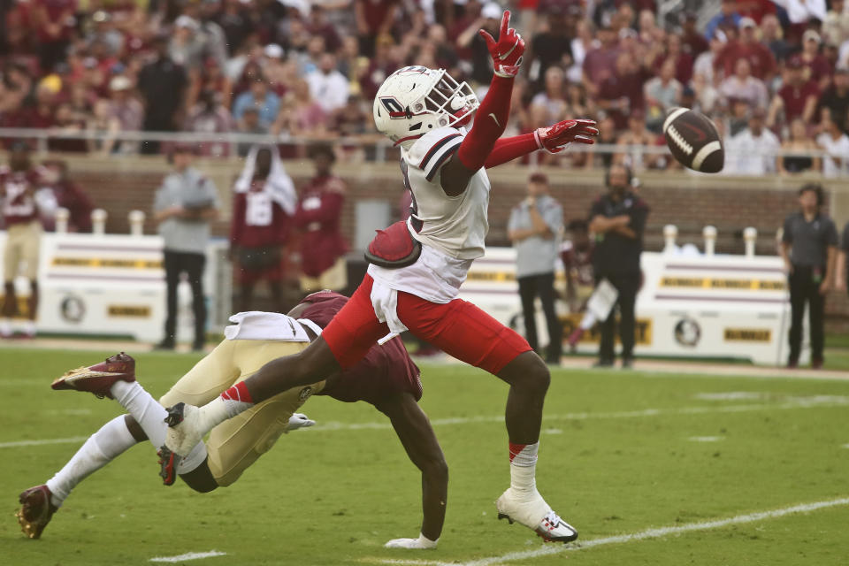 Florida State wide receiver Malik McClain, left, tumbles to the ground after being interfered with by Duquesne defensive back Tim Lowery, right, in the second quarter of an NCAA college football game Saturday, Aug. 27, 2022, in Tallahassee, Fla. (AP Photo/Phil Sears)