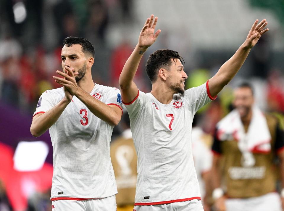 Montassar Talbi L and Youssef Msakni of Tunisia greet the audience after the Group D match between Denmark and Tunisia at the 2022 FIFA World Cup at Education City Stadium in Al Rayyan, Qatar, Nov. 22, 2022. (Photo by Xia Yifang/Xinhua via Getty Images)