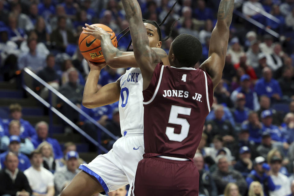 Kentucky's Rob Dillingham, left, is pressured by Mississippi State's Shawn Jones Jr. (5) during the first half of an NCAA college basketball game Wednesday, Jan. 17, 2024, in Lexington, Ky. (AP Photo/James Crisp)