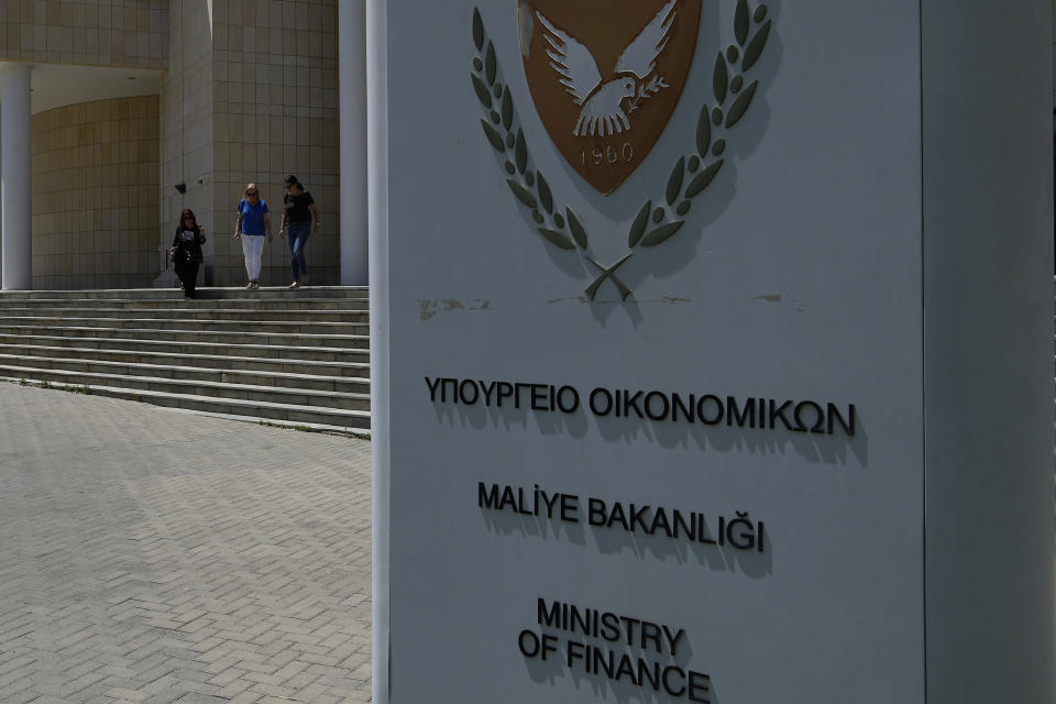 Women leave the Ministry of Finance building in capital Nicosia in the eastern Mediterranean island of Cyprus, on Wednesday, June 7, 2023. When the U.S. and U.K. in April included a handful of Cypriot nationals and Cyprus-registered companies as part of another global crackdown on 'enablers' helping Russian oligarchs skirt sanctions, the perception that the island nation somehow remains Moscow's financial lackey again loomed large. (AP Photo/Petros Karadjias)