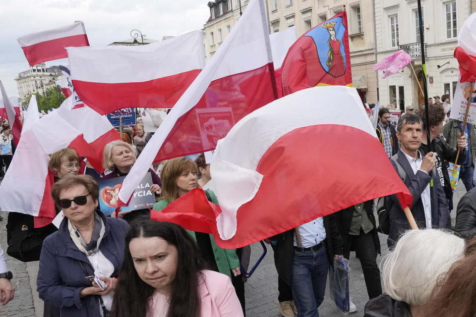 Opponents of abortion walk in a march in support of every conceived life and against steps taken by the new government to liberalize Poland's strict law and allow termination of pregnancy until the 12th week, in Warsaw, Poland, on Sunday, April 14, 2024. Last week, Poland's parliament, which is dominated by the liberal and pro-European Union ruling coalition, voted to approve further detailed work on four proposals to lift the near-ban on abortions. (AP Photo/Czarek Sokolowski)