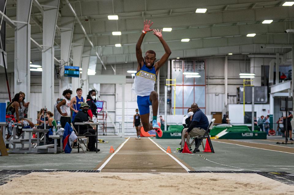 Cummings High School senior Christian Gore competes in the triple jump during Friday's NCHSAA Class 1-A / 2-A state championships for indoor track and field.