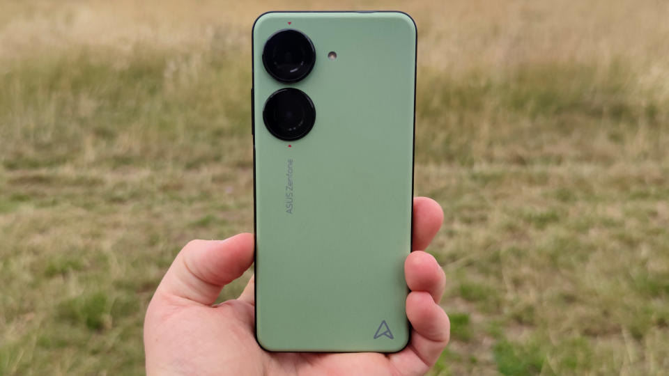 The Asus Zenfone 10 on a bench, with a field in the background