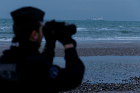 A French gendarme patrols the beach in Wissant, France, January 11, 2019. Picture taken January 11, 2019. REUTERS/Pascal Rossignol