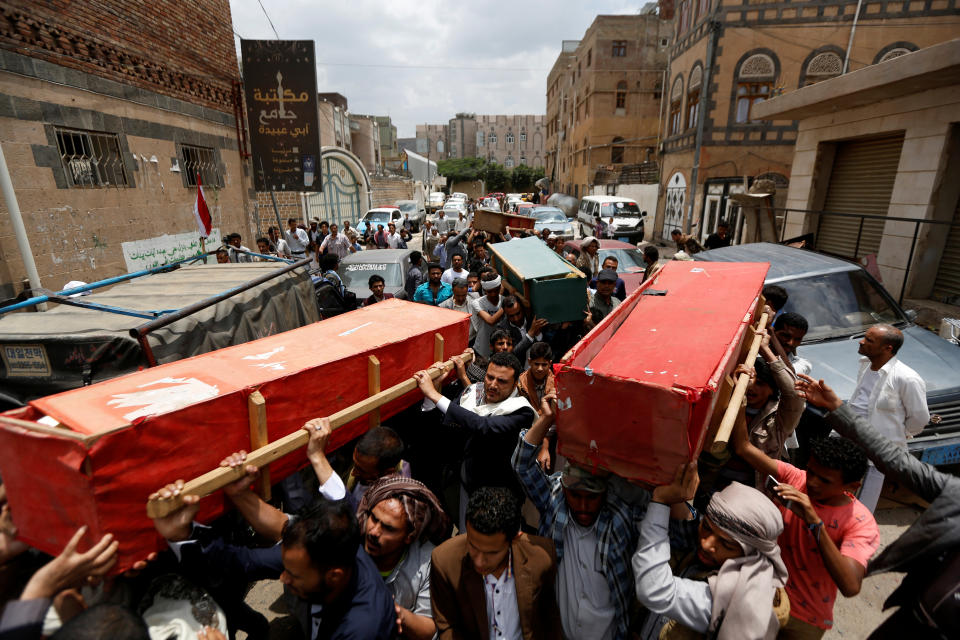 Mourners carry coffins to a mosque for prayers during the funeral of eight family members killed by a Saudi-led airstrike in Sanaa, Yemen, Aug. 26, 2017. (Photo: Khaled Abdullah/Reuters)