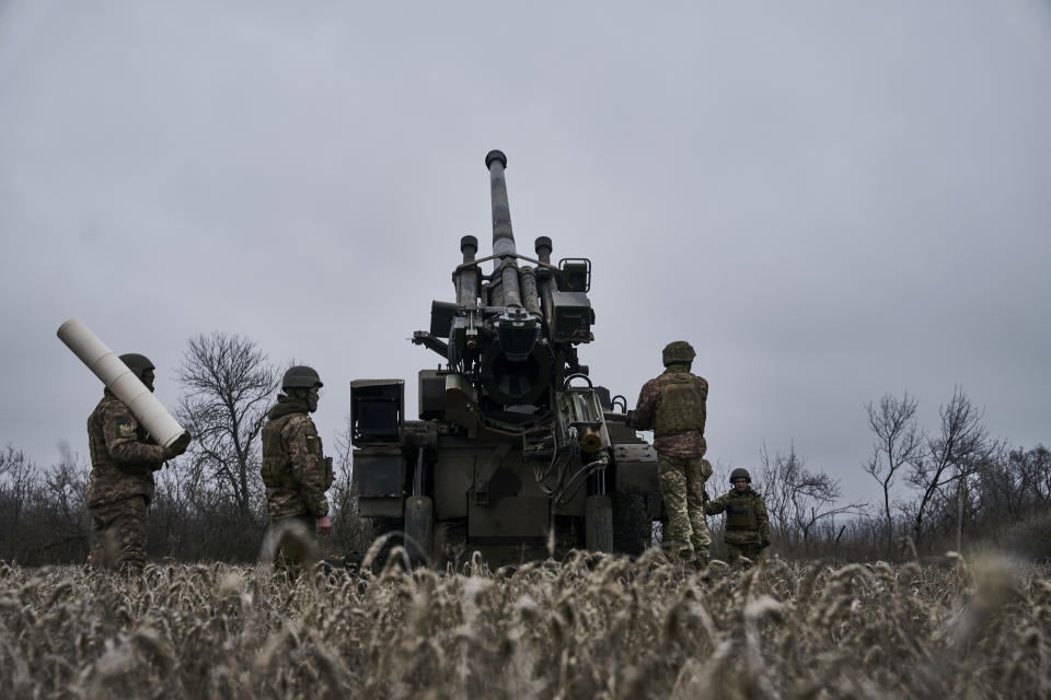 Ukrainian soldiers prepare to fire a French-made CAESAR self-propelled howitzer towards Russian positions near Avdiivka, Donetsk region, Ukraine, Monday, Dec. 26, 2022. (AP Photo/Libkos)