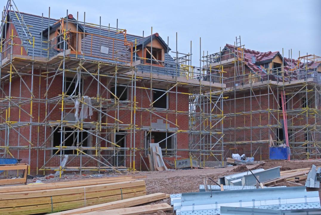 New development of family sized four bed properties, with scaffolding on a building site, Cheshire, England, UK, WA4
