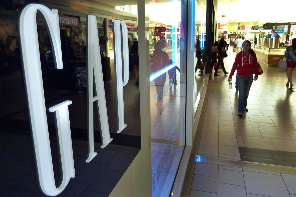 FILE-In this May 14, 2012 file photo, shoppers walk by the GAP store at a shopping mall in Peabody, Mass. Doris Fisher and her late husband Donald founded the Gap in San Francisco in 1969. Gap Inc. has grown to include Banana Republic and Old Navy brands, among others, and operates over 3,000 stores across the world. Fisher is 42nd on Forbes's 2012 400 list. (AP Photo/Elise Amendola. File)