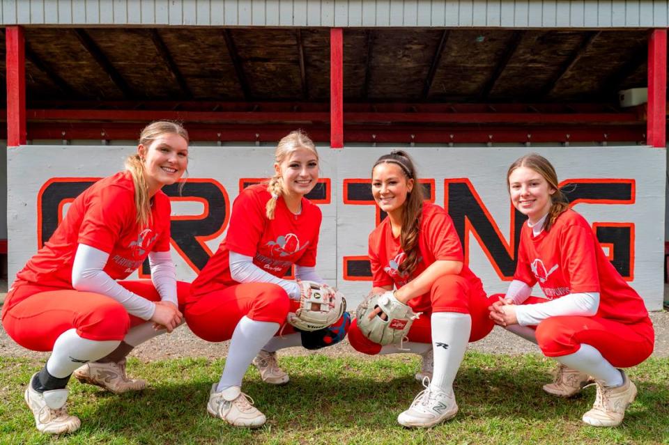 Orting High School softball players (from left) senior pitcher Kaylee Gresko, junior catcher Miken Jacobsen, senior shortstop Abbi Almont, and sophomore third baseman Madalynn Halte, pose for a portrait in Orting, Wash., on Monday, April 24, 2023. Pete Caster/Pete Caster / The News Tribune