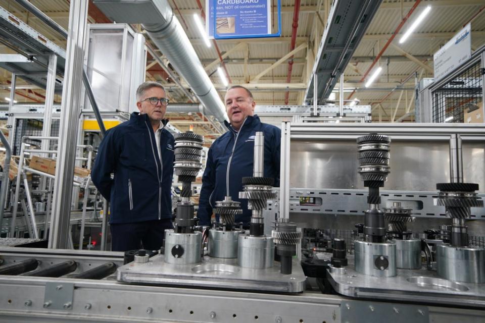 Ford of Europe president Stuart Rowley president talks with plant manager Andy Roche, in front of transmission components at the car manufacturing facility in Halewood, Merseyside (Peter Byrne/PA) (PA Wire)