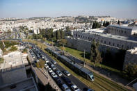 FILE PHOTO: A general view shows Jerusalem's light rail tram as it passes by the old city's walls in Jerusalem November 13, 2014. REUTERS/Ronen Zvulun/File Photo