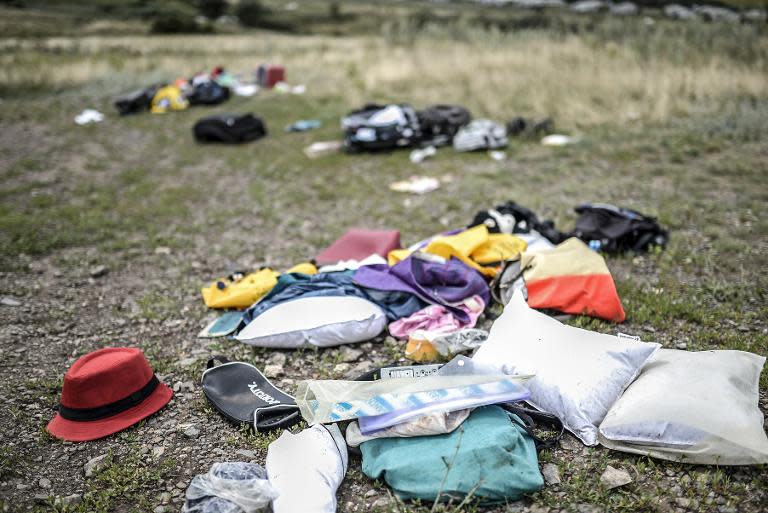 Belongings are scattered at the crash site of a Malaysia Airlines plane in Grabove on July 20, 2014
