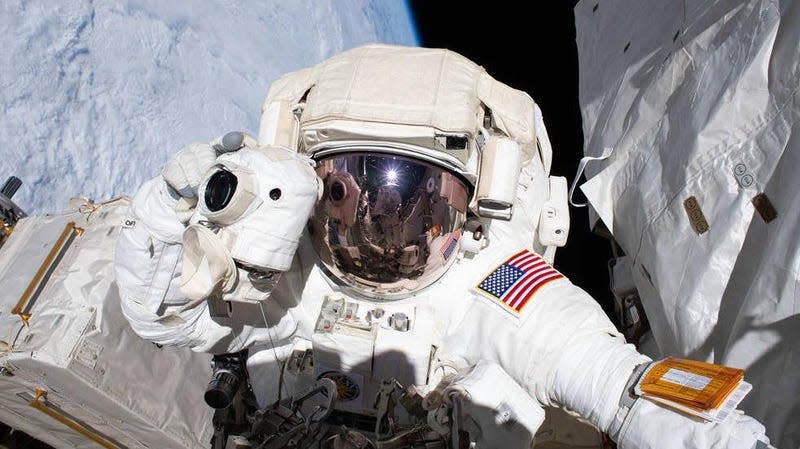 NASA astronaut Andrew Morgan prepares to take a photograph while conducting a spacewalk outside the International Space Station Nov. 22, 2019.