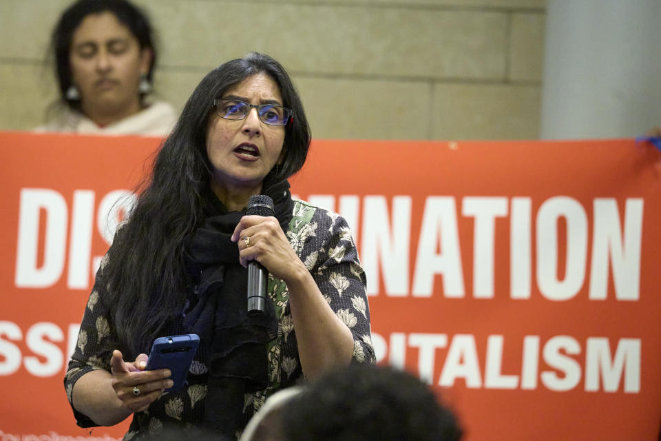 FILE - Seattle Council Member Kshama Sawant talks to supporters after the passage of an ordinance she sponsored add caste to anti-discrimination laws, Tuesday, Feb. 21, 2023, in a meeting room of the Seattle City Hall. In February, Seattle became the first U.S. city and the first jurisdiction outside South Asia to add caste to its anti-discrimination laws. (AP Photo/John Froschauer, File)