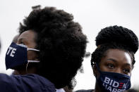 Women listen during a drive-in rally for Democratic presidential candidate former Vice President Joe Biden at Cellairis Amphitheatre in Atlanta, Tuesday, Oct. 27, 2020. (AP Photo/Andrew Harnik)