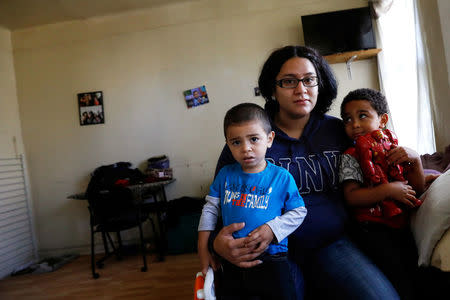 Natalia Rollins poses with her children (R) Randy, 4, and Noah,2, at their apartment in the Coney Island section of the Brooklyn borough of New York, U.S., October 27, 2017. REUTERS/Shannon Stapleton