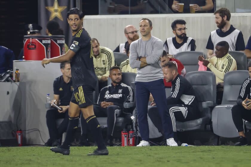 Los Angeles FC head hoach Steve Cherundolo watches at forward Carlos Vela (10) during the first half of an MLS playoff soccer match against the LA Galaxy on Thursday, Oct. 20, 2022, in Los Angeles. (AP Photo/Ringo H.W. Chiu)