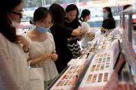 Customers wearing face masks shop at a Chinese cosmetics brand Perfect Diary store, following the coronavirus disease (COVID-19) outbreak in Beijing