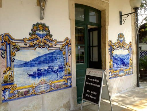 A sign advertising wine tasting is displayed outside a wine shop at the historic train station in Douro. Responding to demand, port shippers have been investing in upscale lodgings as well as restaurants, walking trails, tasting rooms, shops and museums