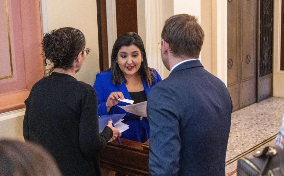 State Sen. Melissa Hurtado, D-Sanger, takes a card from a lobbyist on Tuesday.