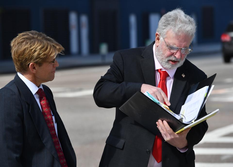 Self-proclaimed "Annuity King" Phillip Roy Wasserman of Sarasota, right, with his attorney, William Sansone, refers to a document when he stopped to talk to a Sarasota Herald-Tribune reporter outside the Sam M. Gibbons Federal Courthouse in Tampa on Wednedsay, Jan. 31, 2024. Wasserman was appearing for a sentencing hearing after being found guilty on nine felony counts including wire fraud and mail fraud, as well as conspiracy to commit wire and mail fraud, in connection with FastLife, an online life, health and annuity market firm he started.