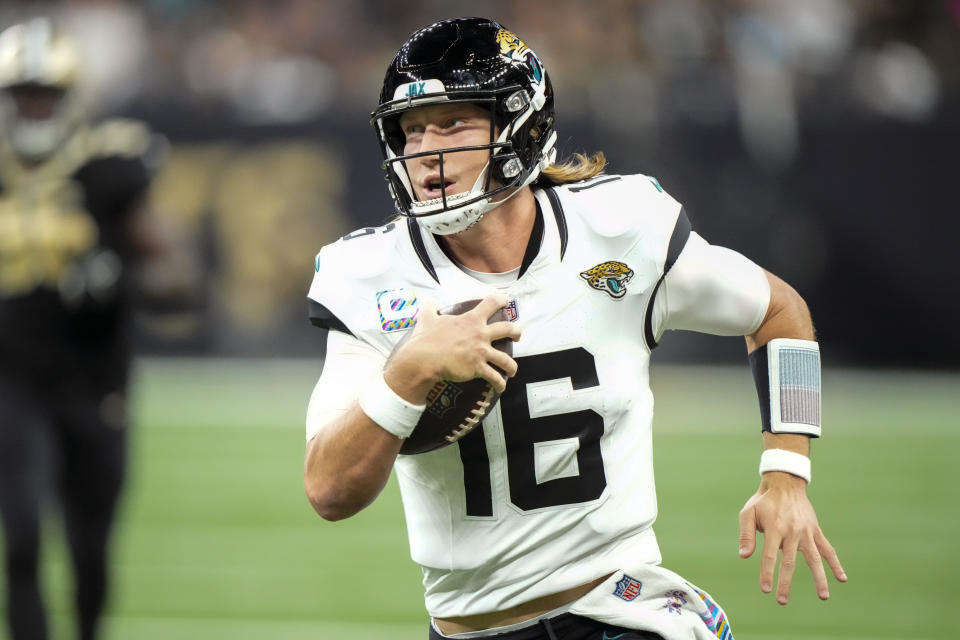 Jacksonville Jaguars quarterback Trevor Lawrence (16) runs for yardage against the New Orleans Saints in the first half of an NFL football game in New Orleans, Thursday, Oct. 19, 2023. (AP Photo/Gerald Herbert)